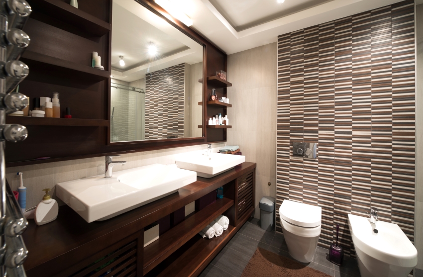 Bathroom with tile floor, open shelves, two washbasins, and wooden countertops