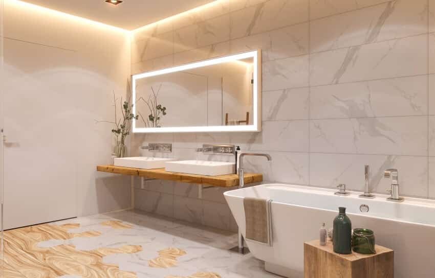 Bathroom with vessel sinks, wood floating vanity, freestanding tub, and LED strip ceiling lights