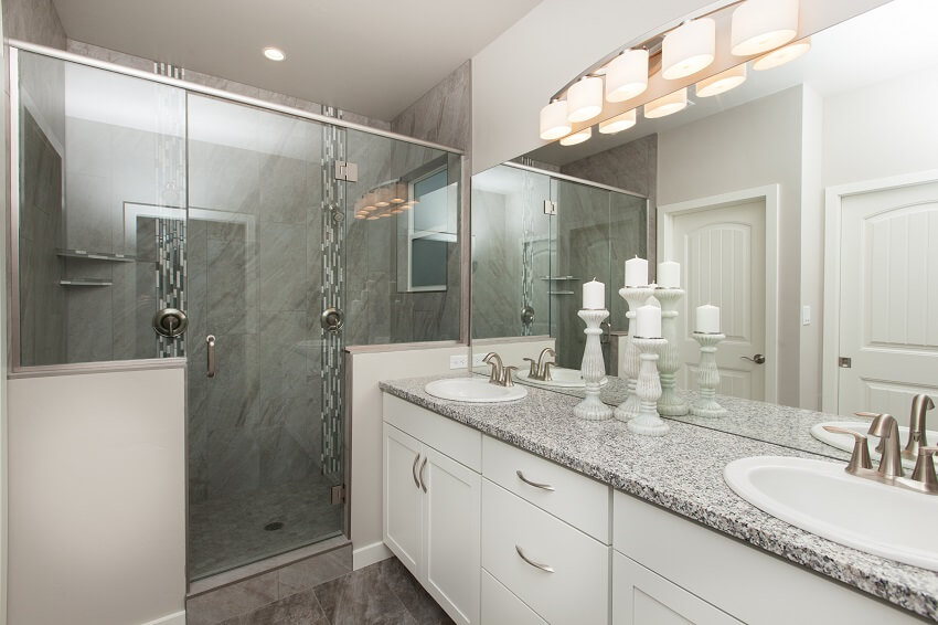 Beautiful bathroom with granite vanity counter and glass door shower