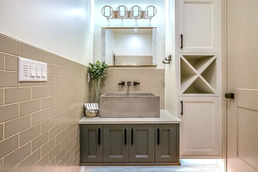 Big vessel concrete sink with subway tiles and storage cabinets 