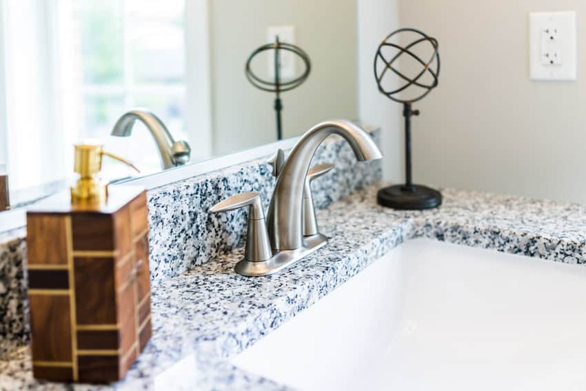 Bianco Antico Granite with faucet in brushed metal finish