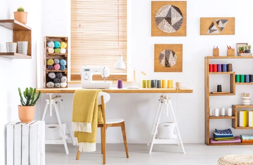Bright craft room with wooden desk shelves and chairs