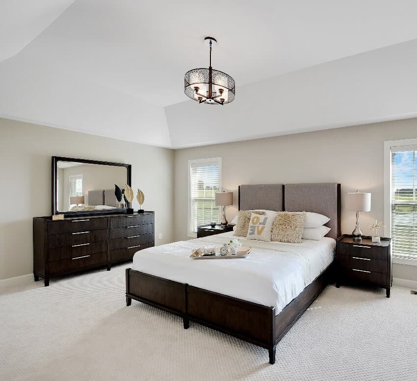 Contemporary bedroom with a pendant light, dark brown bed and drawers