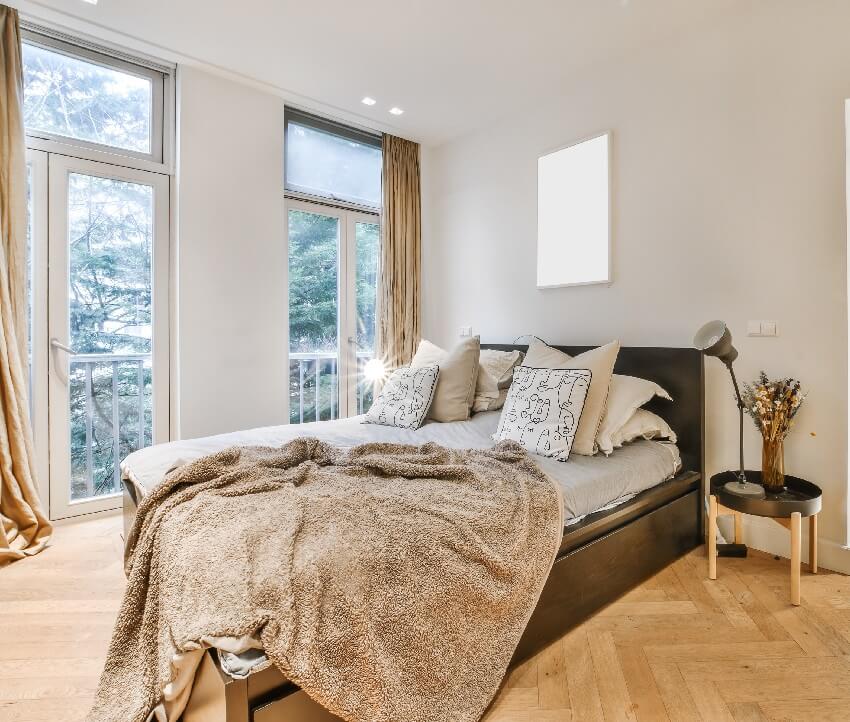 A cozy bedroom with brown bed and light gray walls