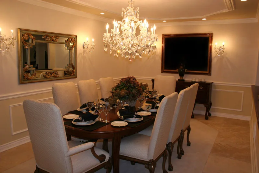 Room with decorative mirror on the wall and classic candle style chandelier