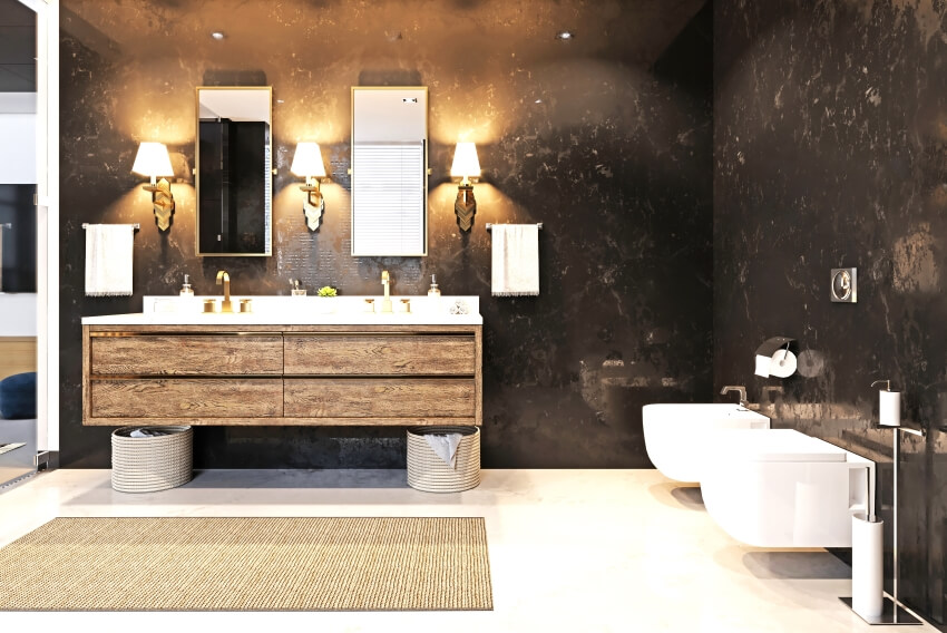 Double sink vanity and a sconce on the black marble wall in a bathroom