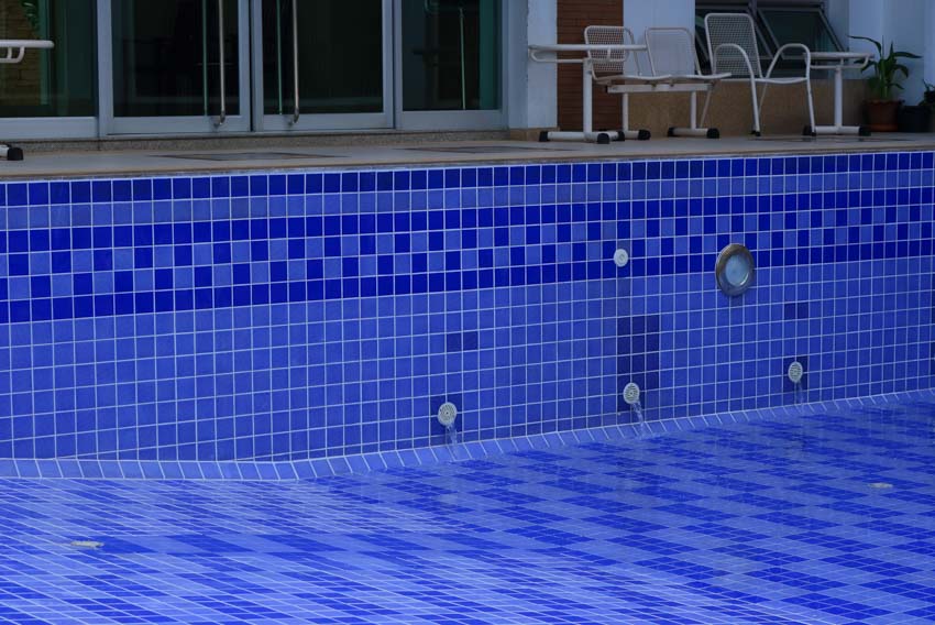 Empty pool with liner, and mosaic tile wall