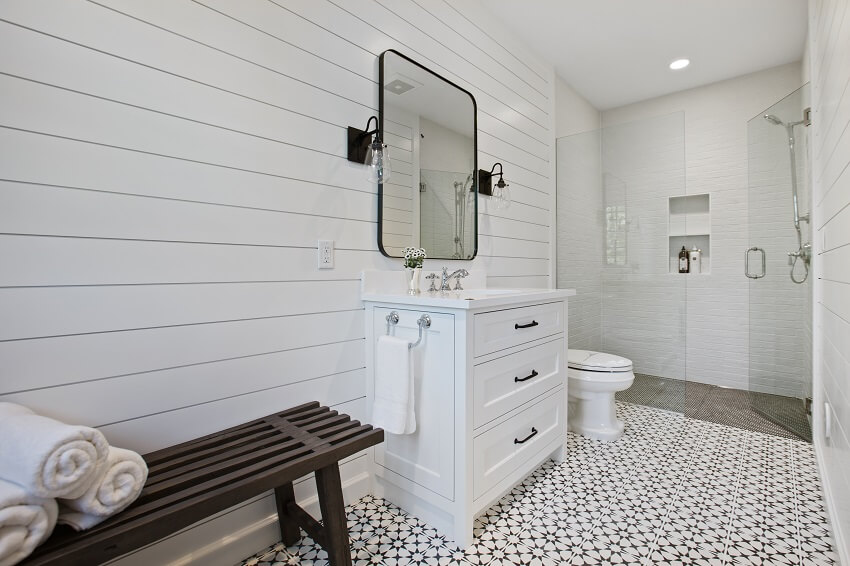 Gorgeous white bathroom with freestanding vanity and a wooden bench