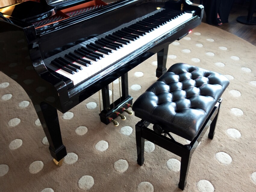 Grand piano and leather bench on a polka dot carpet
