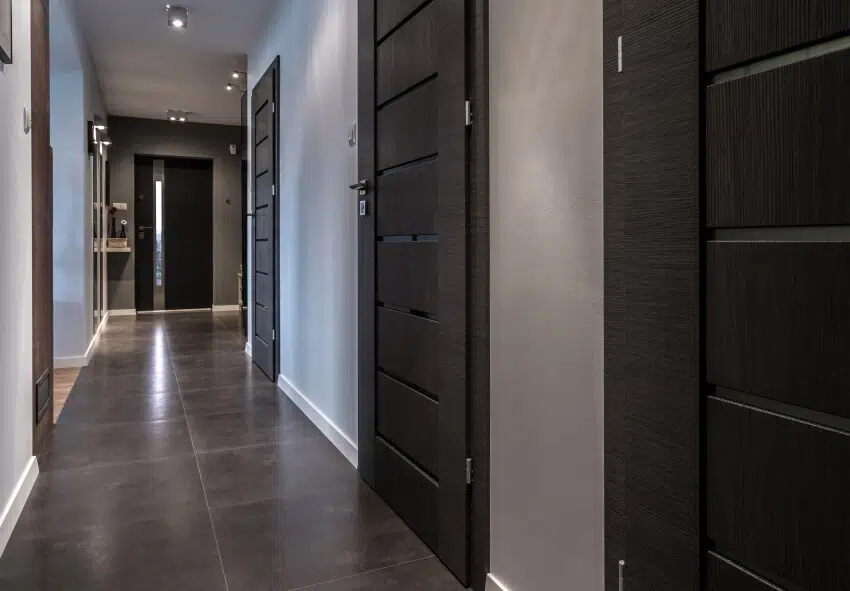 Hallway with black doors