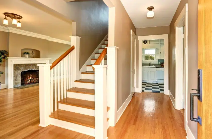 Hallway with hardwood floor, ceiling lights and fireplace
