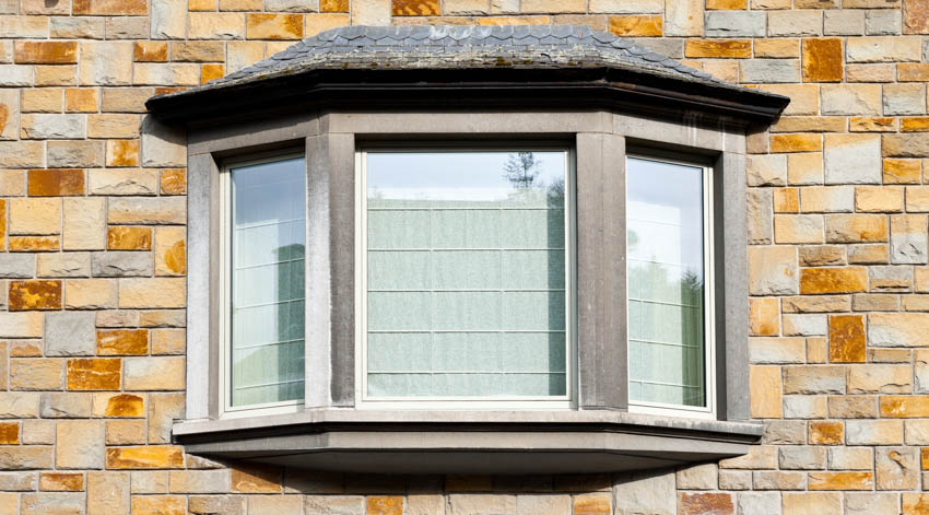 Canted style window with curtains