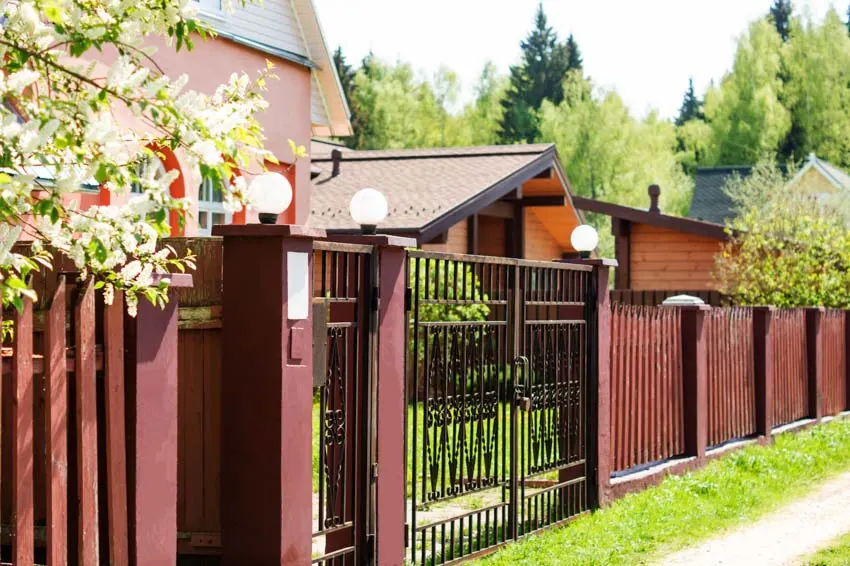 House exterior with steel gate, and mahogany fence