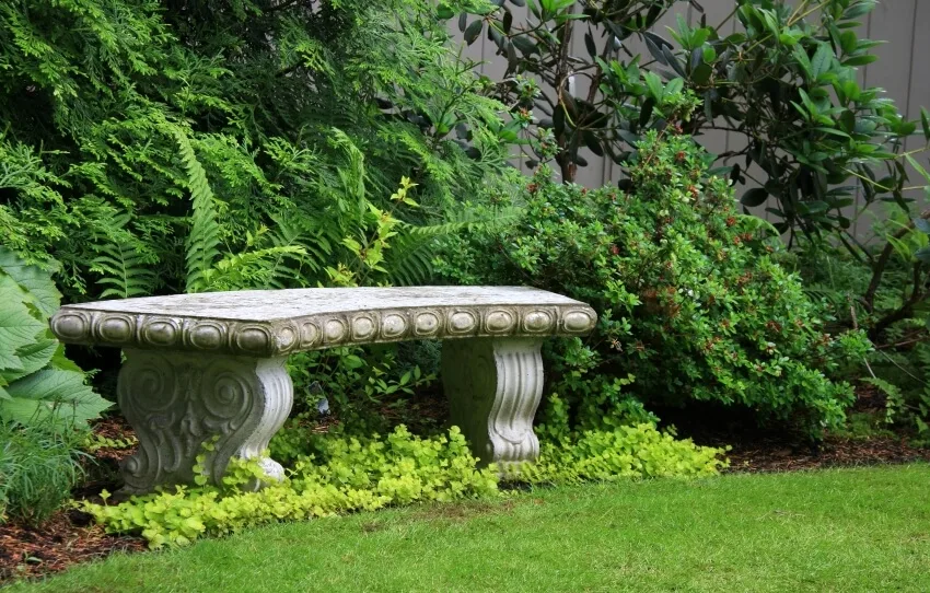 Intricate granite bench in a beautiful garden
