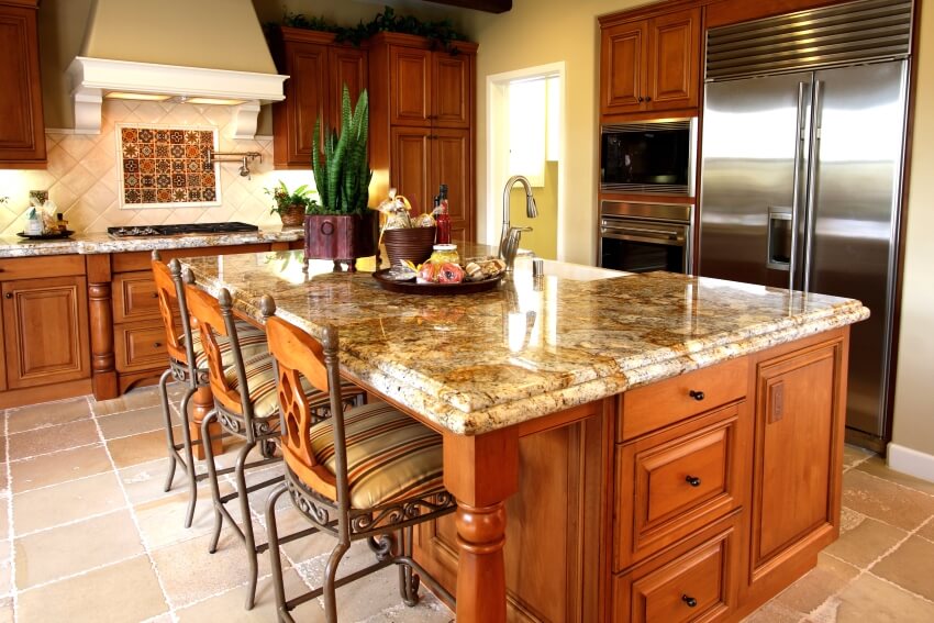 Kitchen with granite countertops, limestone tile floors, and a huge island with breakfast bar