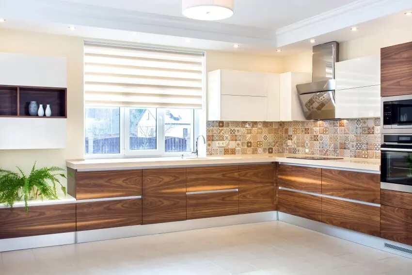 Kitchen with laminate cabinets, Roman shades and patterned backsplash