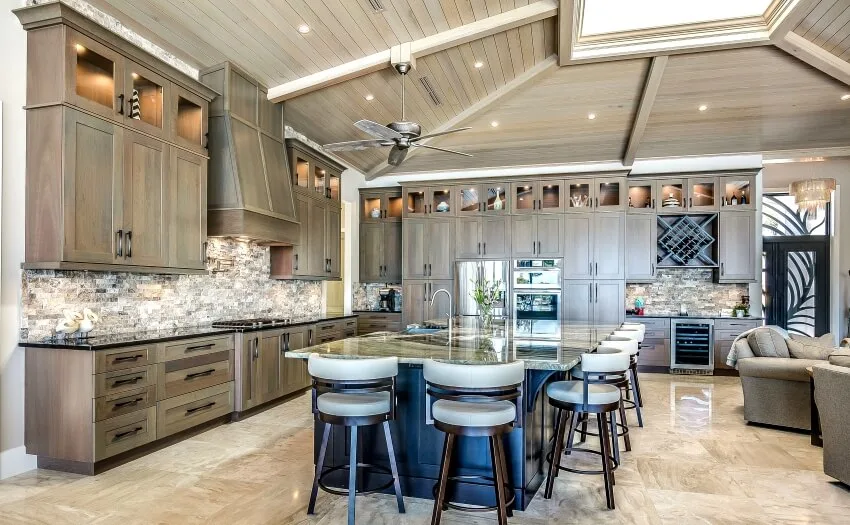 Kitchen with large island, skylight window, and matching brown cabinets and hut style ceiling