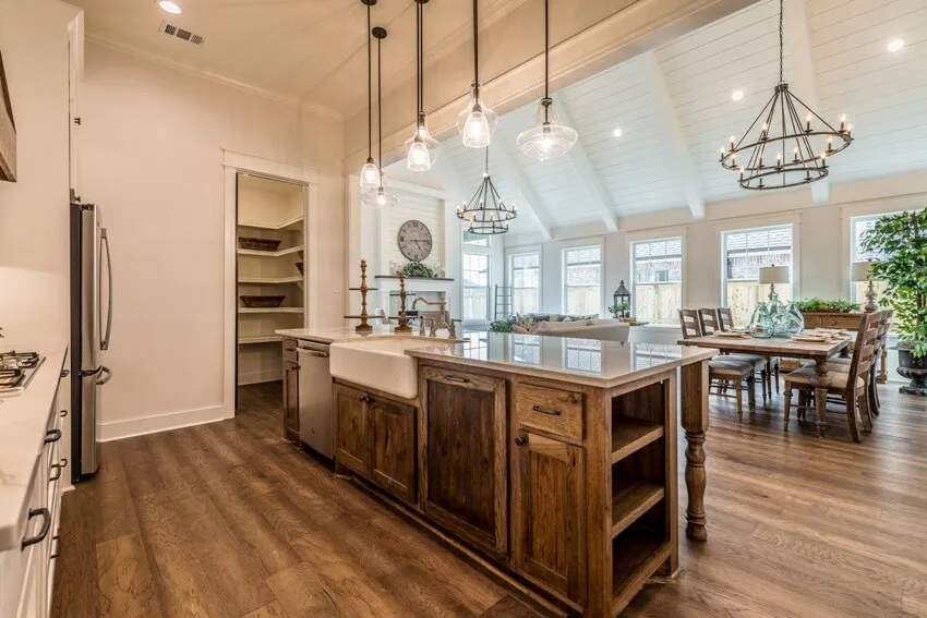 Kitchen with beadboard ceiling and weathered look island with granite countertop