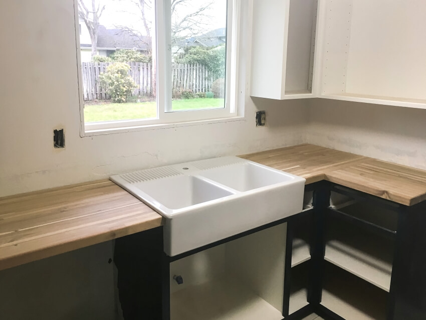 Large sink with built-in shelf and wood countertops