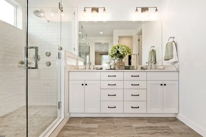 Large glass shower with white cabinet and black hardware