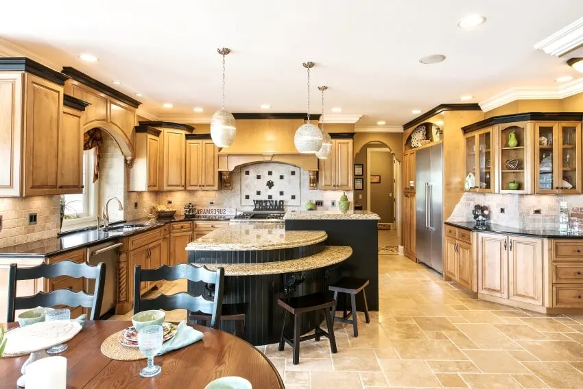 Kitchen with pendant lights, brick backsplash, and black island 