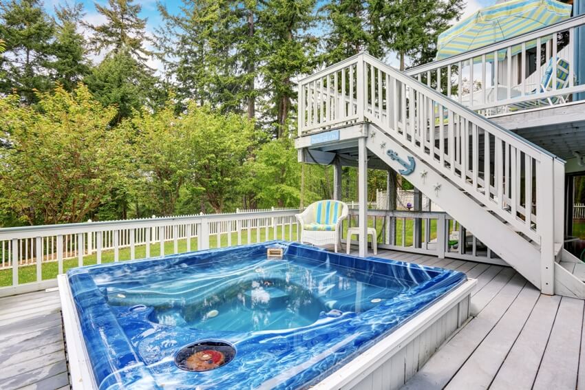 Large marine style home with two level deck and a hot tub