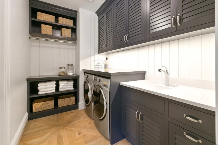 Room with grey shutter door cabinets and wood tiles on the floor
