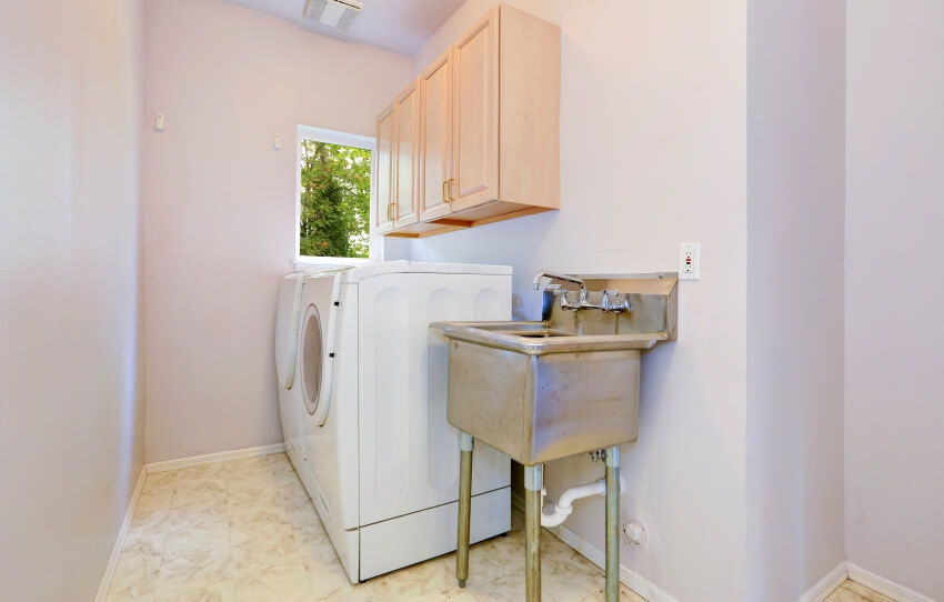 Laundry room with old utility sink and white appliances