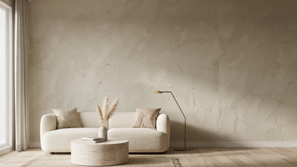 Warm neutral living room with textured liquid wallpaper and a curved boucle sofa