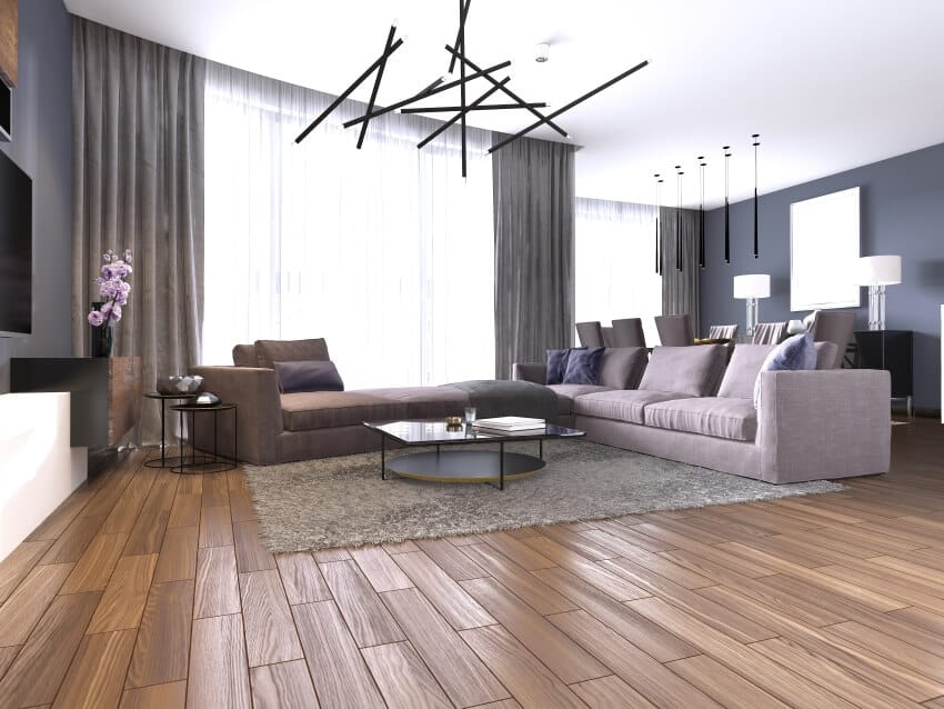 Room with hardwood floors, stylish lighting, and large corner sofa