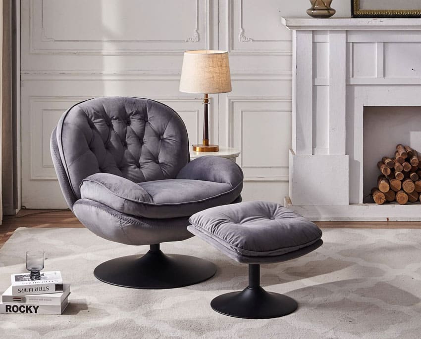 Living room with egg chair, ottoman, fireplace, and gray accent chair