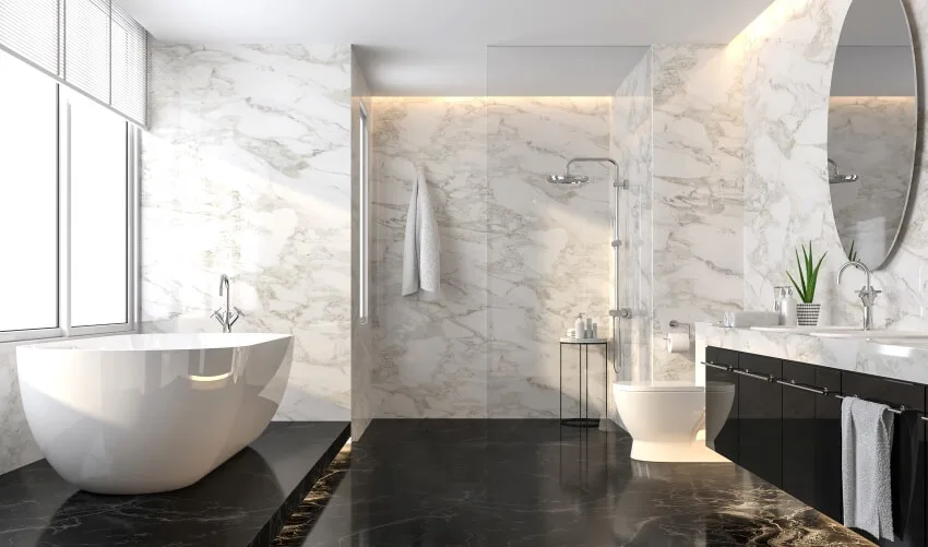 Luxury bathroom with marble colored floor, white stone wall, and freestanding tub