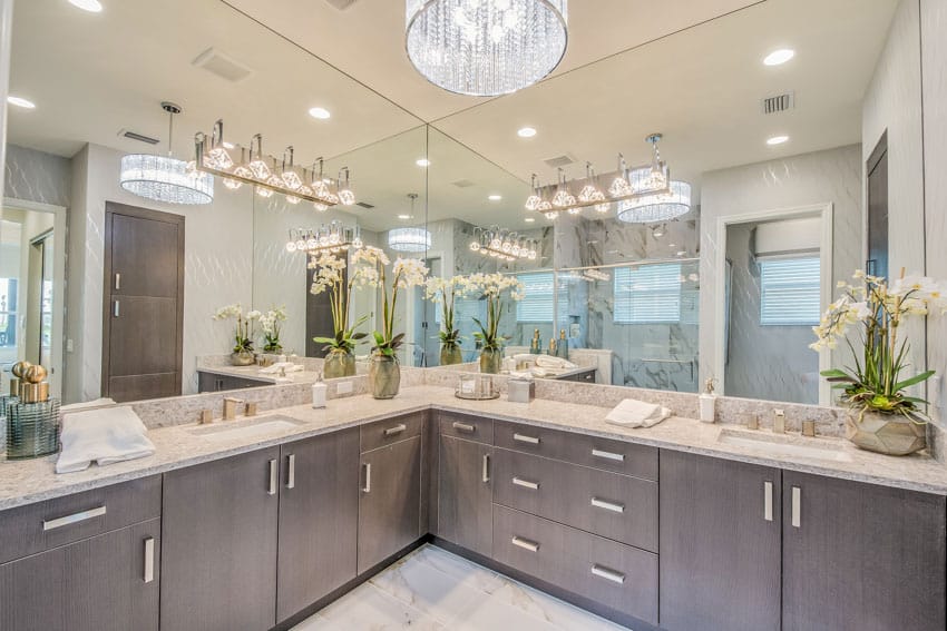 Luxury bathroom with wood cabinet, countertops, mirror, and accent lighting