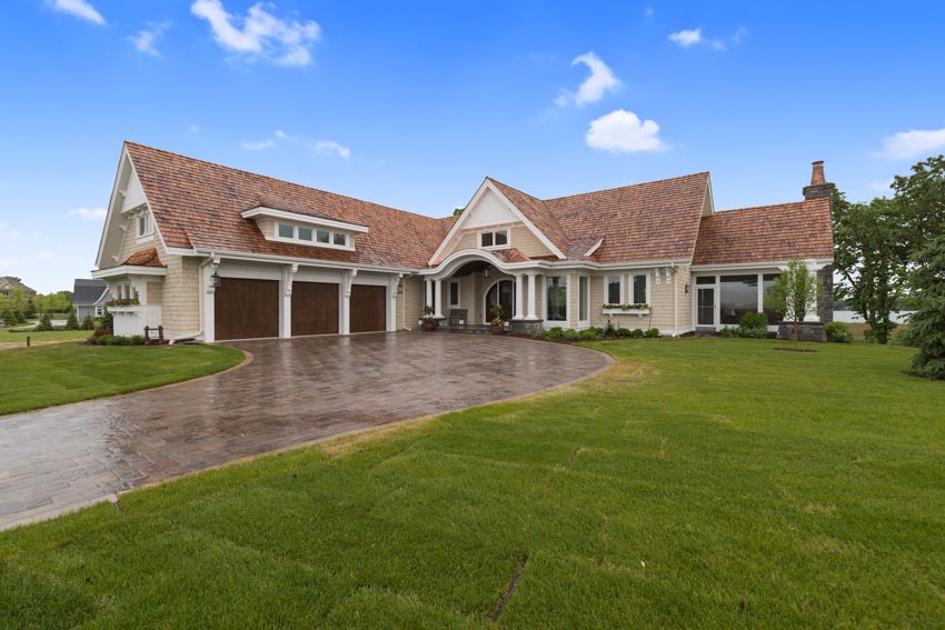 Luxury house with epoxy sealant driveway, pitched roof, and dormer 