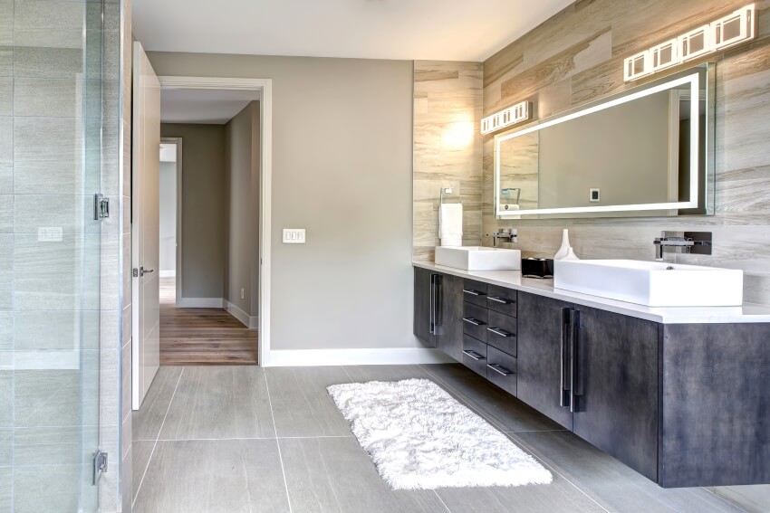 Master bathroom with a dark vanity cabinet, gray tile floor, and glass walk-in shower