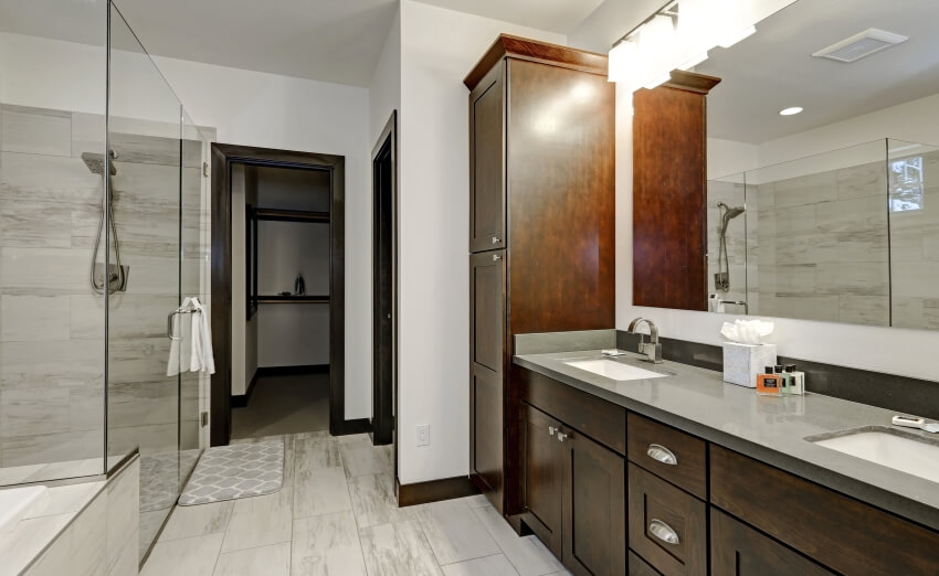 Master bathroom with wooden cabinets, grey paint countertops, and a walk-in shower