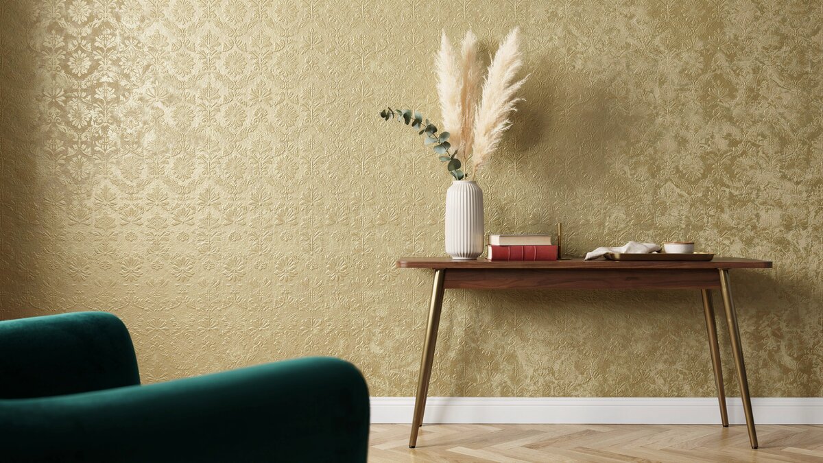 Glamorous gold metallic foil wallpaper behind a wood console with pampas grass