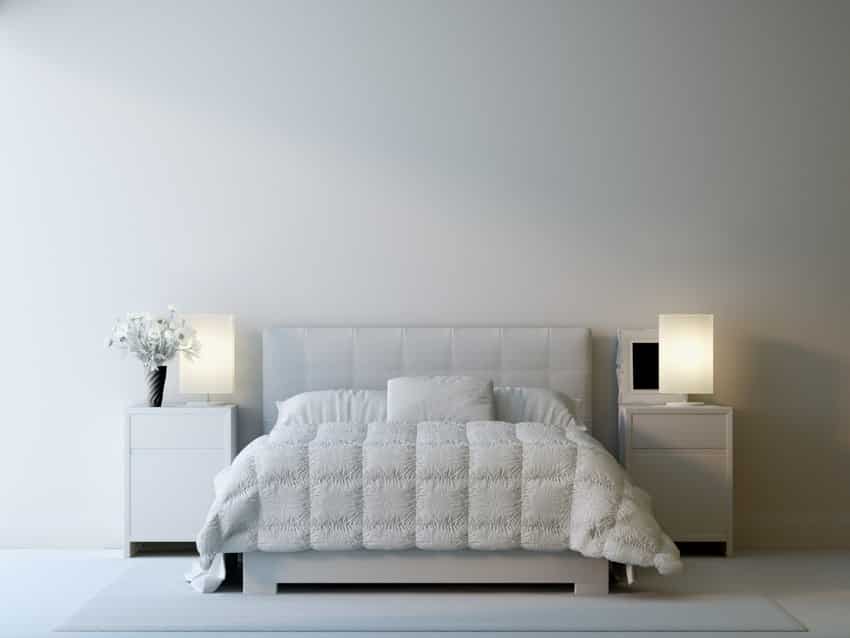 Minimalist bedroom with white comforter, headboard, nightstands, and modern lamps