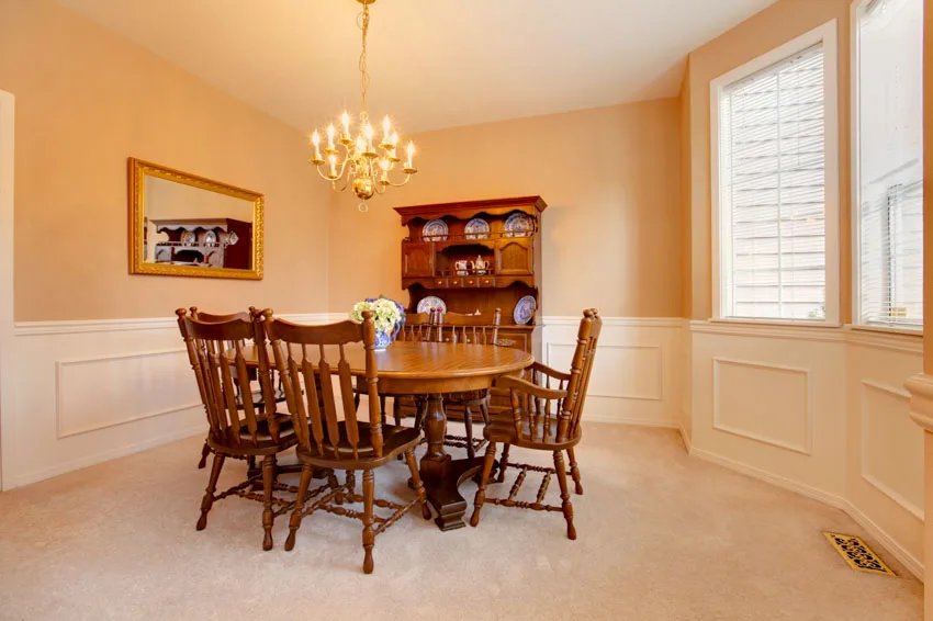 Room with wood table, wainscoting, window, and chandelier