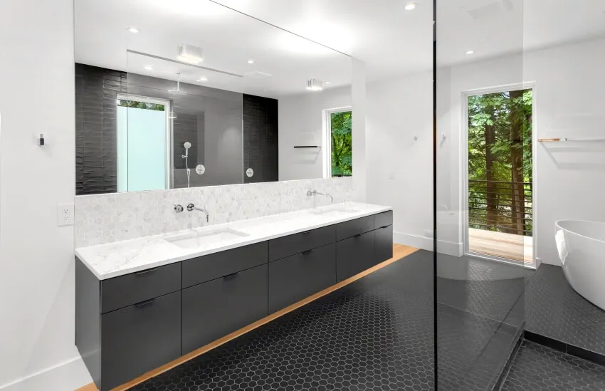 Bathroom with honeycomb tile and a grey vanity with marble top