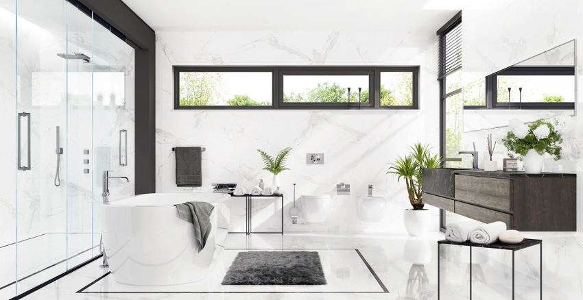 Modern bathroom with soapstone countertop, tub, countertop, and glass door