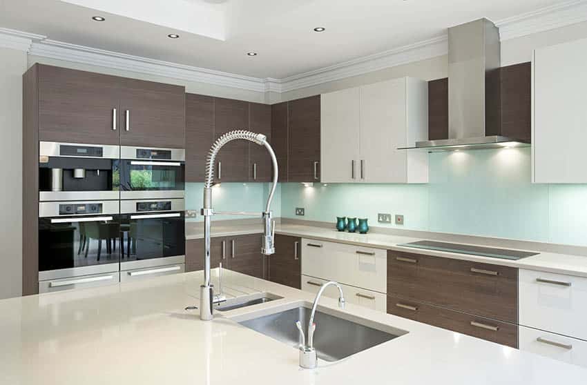 Modern kitchen with white glass countertops light blue glass back painted backsplash
