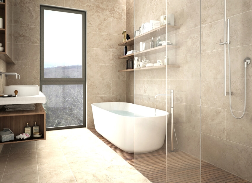 Modern limestone bathroom with freestanding bathtub, shower, and floating shelves with bottles