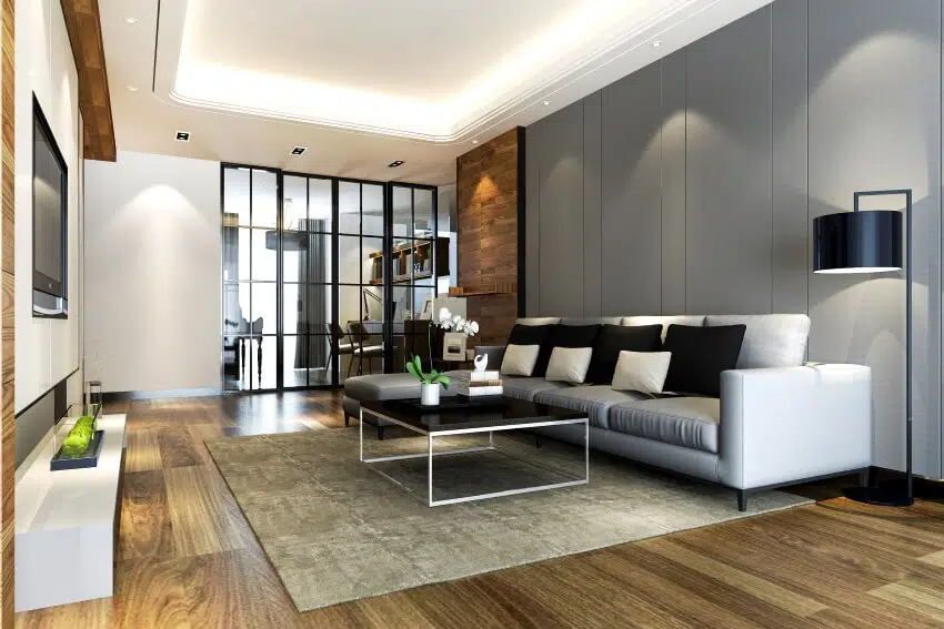 Modern Living room with metal table, grey accent wall and wood flooring