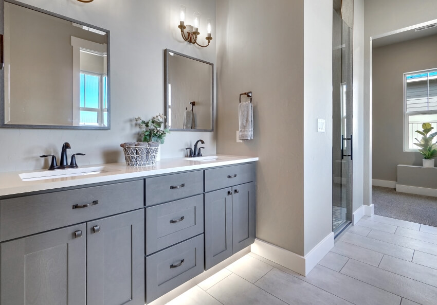 Modern master bathroom light and dark gray interior and double vanity with under cabinet lighting