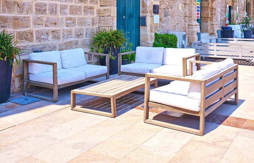 Modern summer furniture on terrace with limestone outdoor tile