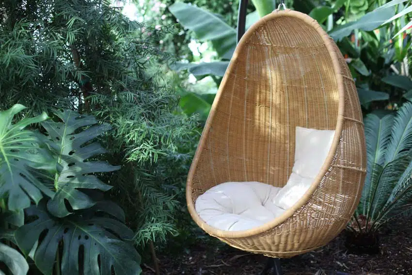 Outdoor area with hanging chair, and cushion