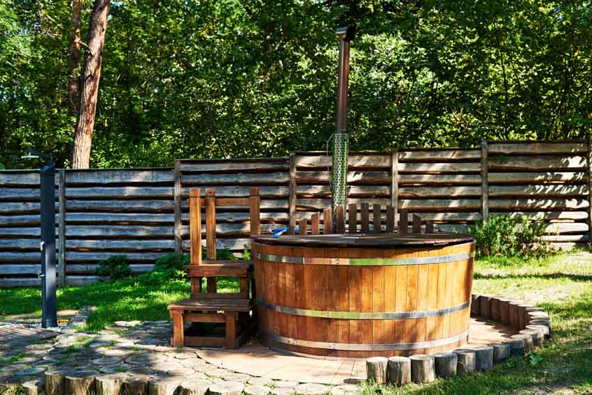 Outdoor area with Japanese style hot tub, and paved walkway