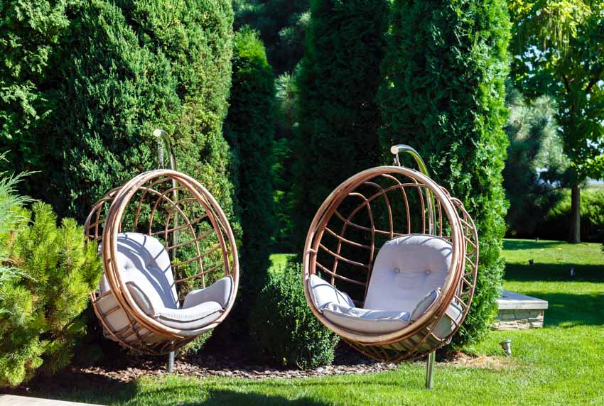 Outdoor area with two egg chairs made of wood