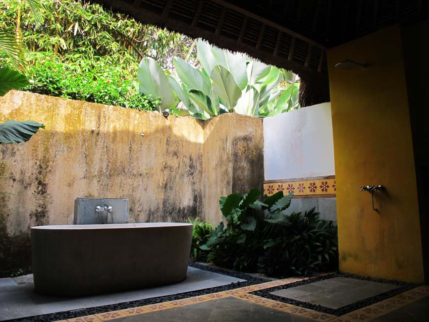 Outdoor bath with tub, tile flooring, and faucet